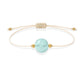 Pulsera de aguamarina natural con hilo color hueso y balines en oro de 18 quilates.