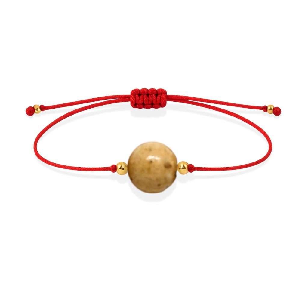 Pulsera de jaspe paisino natural con hilo rojo y balines en oro de 18 quilates.