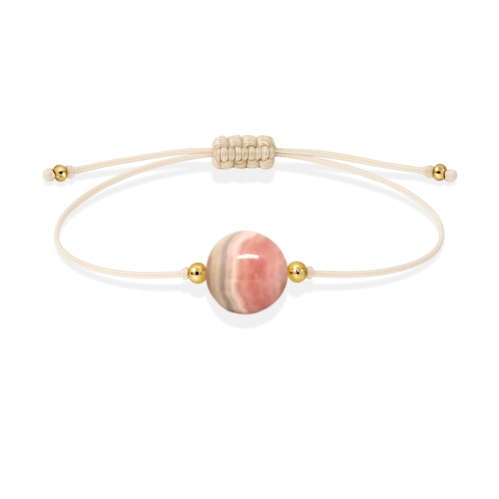 Pulsera de rodocrosita natural con hilo color hueso y balines en oro de 18 quilates.
