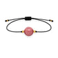 Pulsera de rodonita natural con hilo negro y balines en oro de 18 quilates.